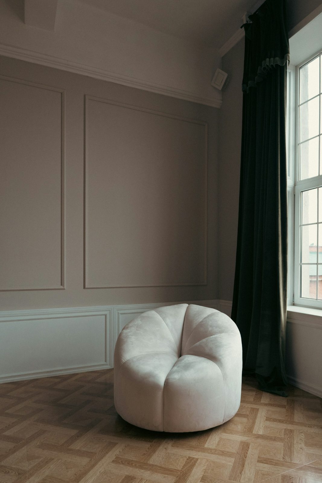 Armchair beside a tall window