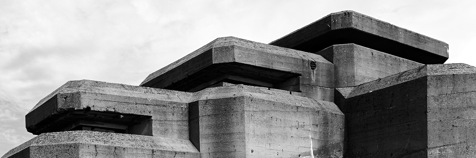 Concrete bunker against a pale sky