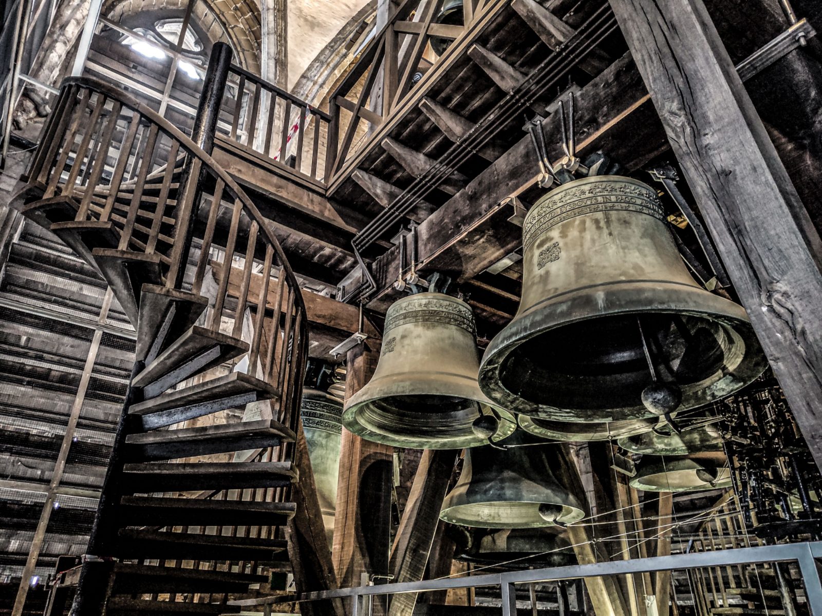 Bells hung in a timber frame, ladder to the right