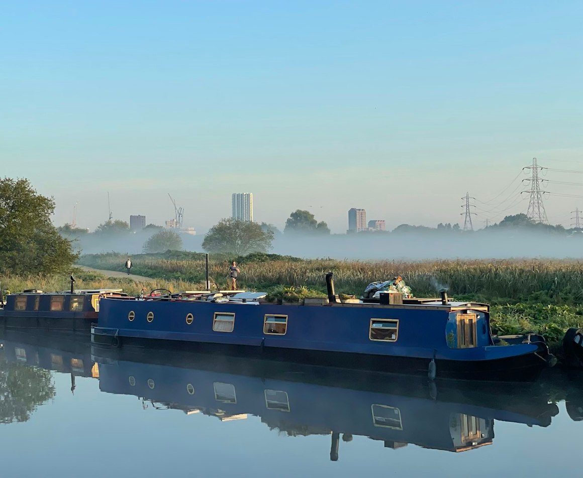 Narrowboats moored in morning mist