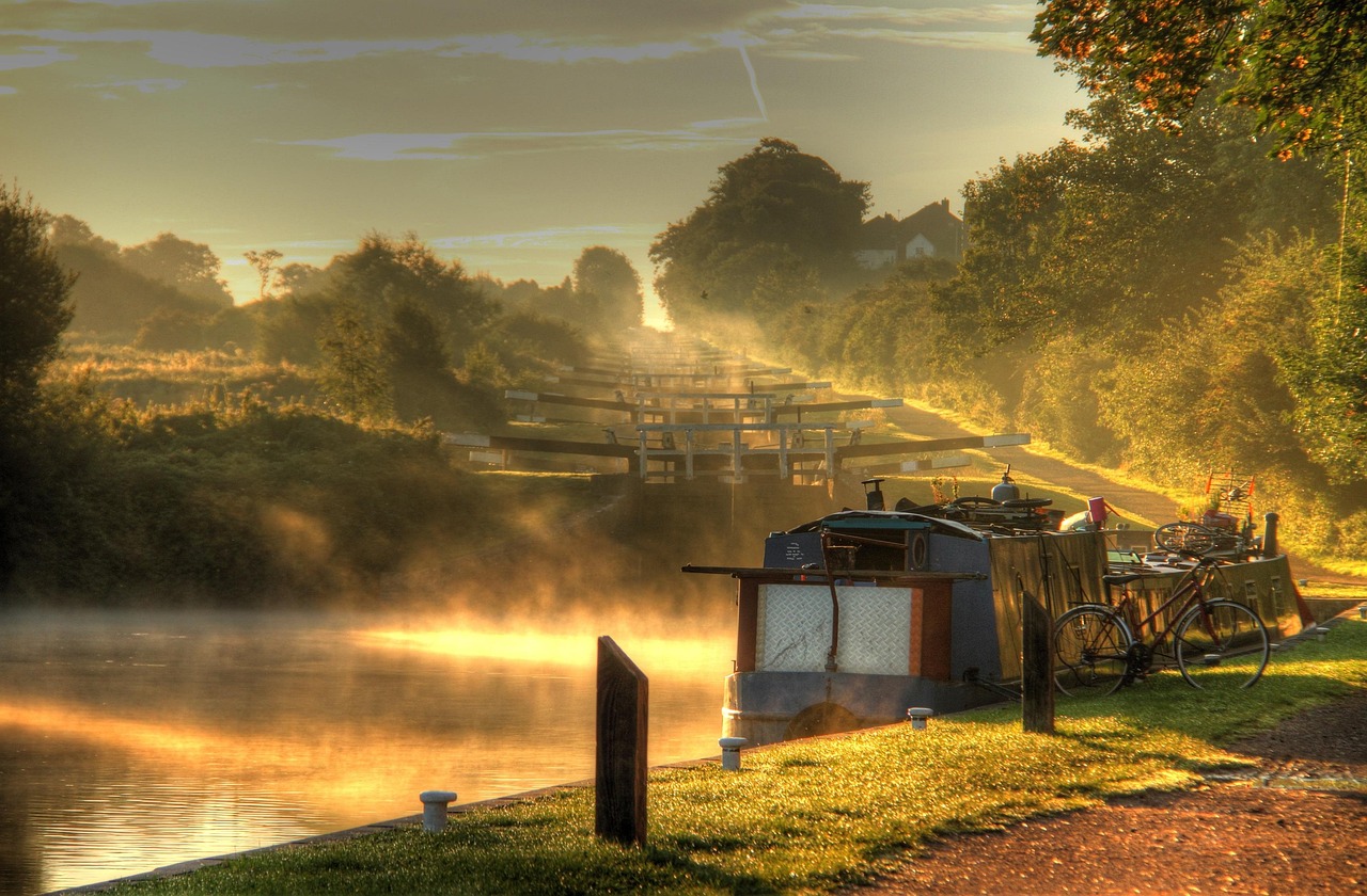 Early mist on a flight, a narrowboat moored below