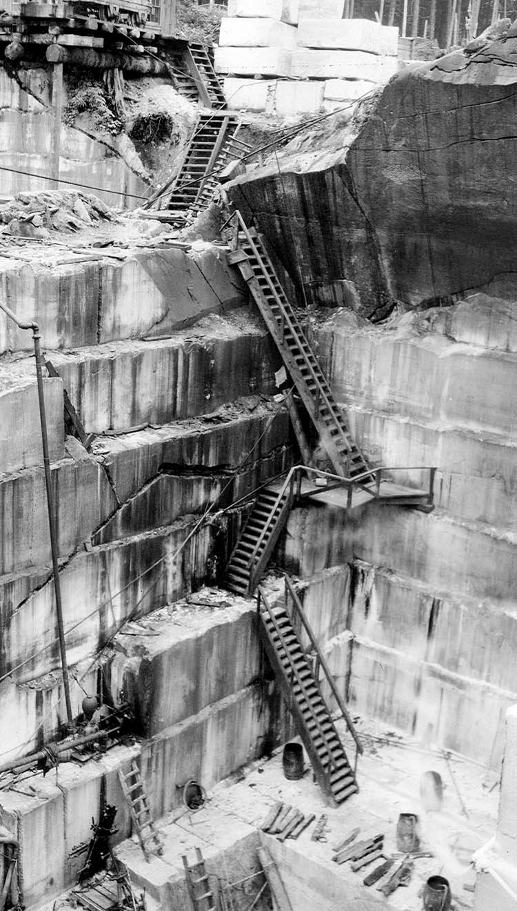 Stepped quarry faces with iron ladders, black and white
