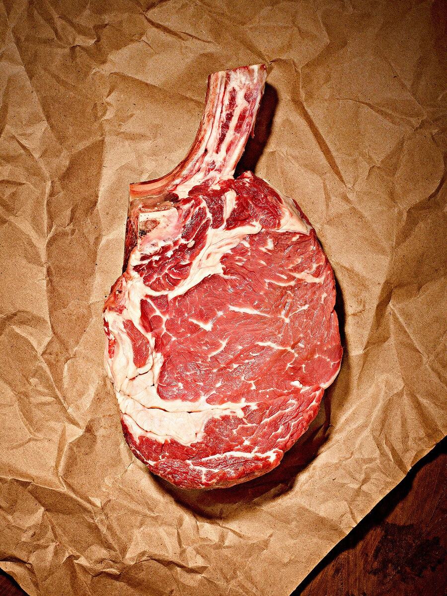 Bone-in rib steak on brown kraft paper