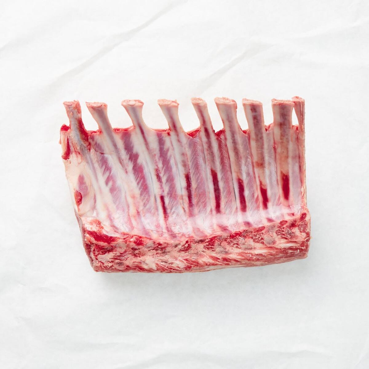 French-trimmed rack of lamb on white paper
