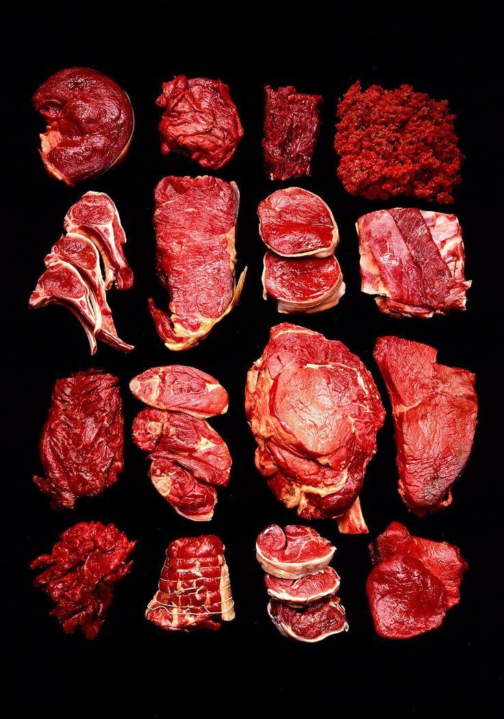 Beef cuts laid out in rows on black