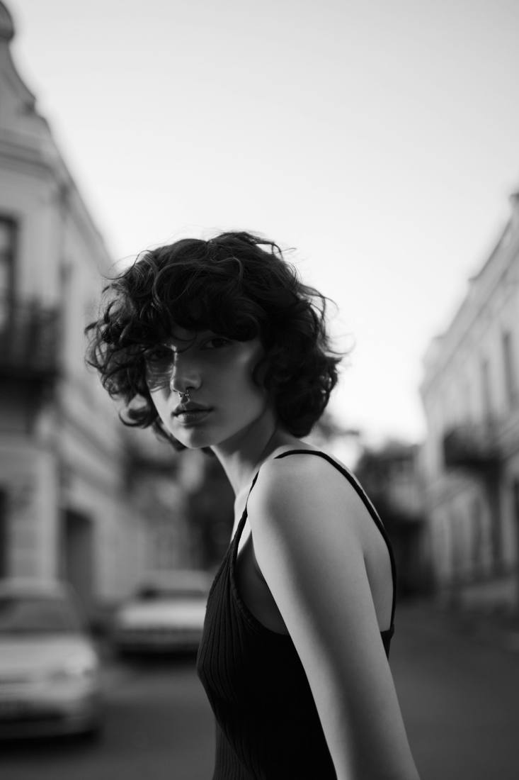 Black and white portrait of a woman in a black dress