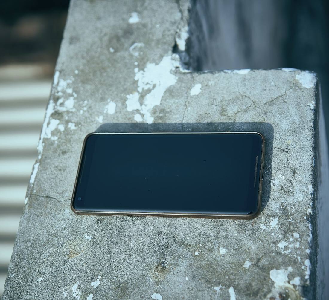 Phone resting on a concrete ledge