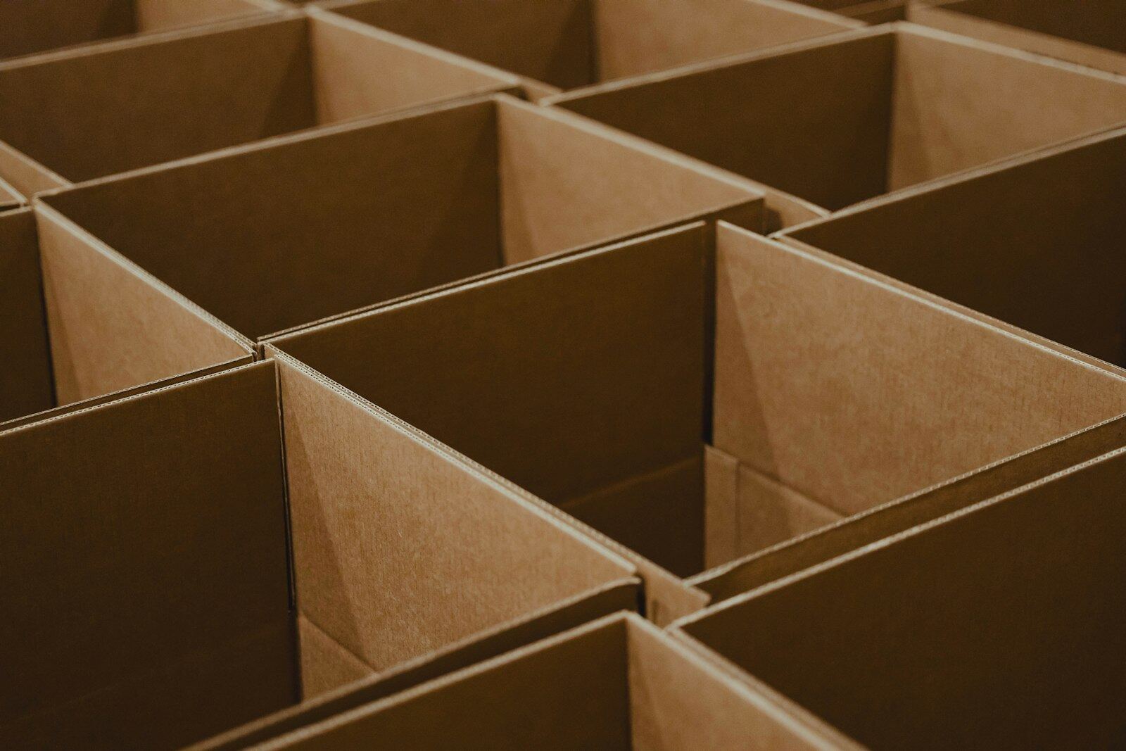 Rows of open empty cardboard boxes seen from above